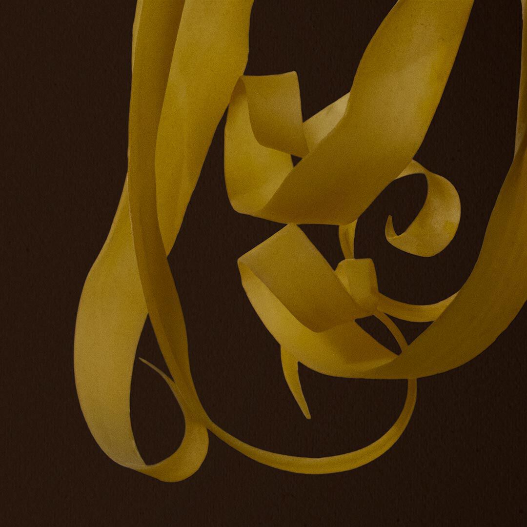 Close-up of curled yellow peel strips against a dark brown background.